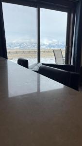 a table and chairs in a room with a view of the desert at Tranquil Retreat in Bozeman