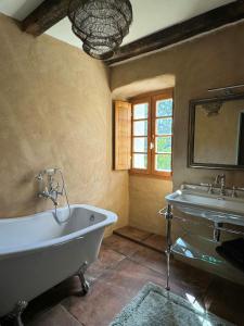 a bathroom with two sinks and a bath tub at Village House With Character In Corsica in Scolca