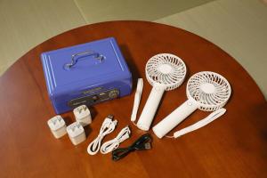 a table with a blue box and some hair brushes at Kamon Inn Uji 2-D in Uji