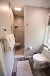 a bathroom with a toilet and a glass shower at Lake Cabin Ideal for Outdoor Adventures in Maine in North Harpswell