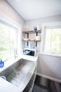 a kitchen with a sink and a window at Lake Cabin Ideal for Outdoor Adventures in Maine in North Harpswell +75 photos