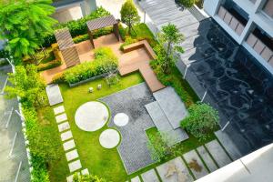 an overhead view of a garden with a bench and table at The Kite Hotel Bangsaen by Koko in Ban Laem Thaen