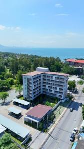 an aerial view of a building with a parking lot at The Kite Hotel Bangsaen by Koko in Ban Laem Thaen
