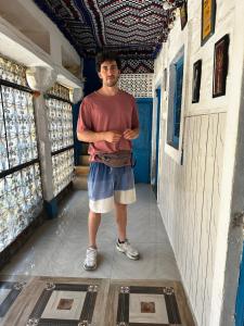 a man standing in a hallway of a building at Mirvana Guest House & Camel safari in Jaisalmer