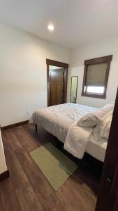 a bedroom with a large bed and a window at Tranquil Retreat in Bozeman