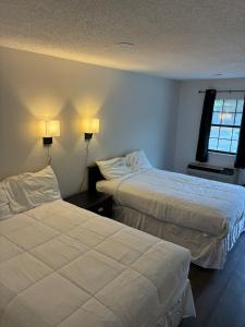 a hotel room with two beds and a window at Suite Stay in Talladega