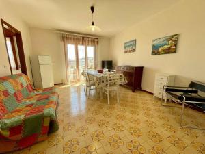 a living room with a couch and a table in it at Apartment in Porto Santa Margherita 53410 in Porto Santa Margherita di Caorle