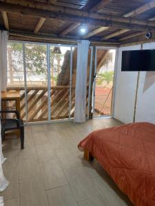 ein Schlafzimmer mit einem Bett und einem großen Fenster in der Unterkunft Villa en Salango con piscina in Salango