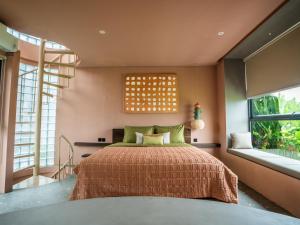 a bedroom with a bed and two windows at Patha Canggu in Canggu +51 photos