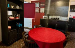 a kitchen with a red table in a kitchen at SUITE 6, Centro de Cuauhtémoc Chihuahua in Cuauhtémoc +7 photos