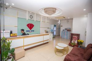 a man is standing at a counter in a store at Ruby Star Hotel Apartment in Vung Tau