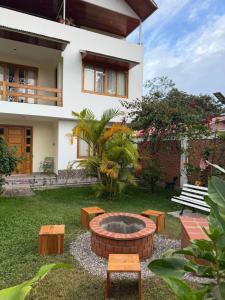 a backyard with a fire pit in front of a house at Casa Oxapampa in Oxapampa +2 photos