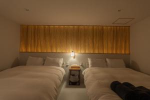 Ένα ή περισσότερα κρεβάτια σε δωμάτιο στο Harukazesou Taishou 200平米貸切戸建 最大20名様 USJ車で20分 無料駐車スペース2台 屋上BBQ