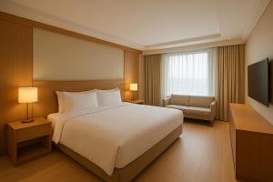 a hotel room with a bed and a television at Busan Seomyeon Nestly Hotel in Busan