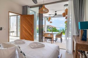 バーン・バンポーにある2br Tropical Villa Elisa Sea View Pool Breakfastのベッドルーム(ベッド1台、テーブル付)、バルコニーが備わります。 +33枚の写真