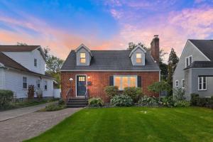 a brick house with a lawn in the yard at Snyder Sanctuary Retreat home in Amherst