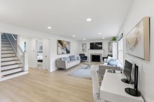 a white living room with a couch and a tv at Snyder Sanctuary Retreat home in Amherst +24 photos