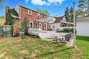 an exterior view of a brick house with a patio at Snyder Sanctuary Retreat home in Amherst
