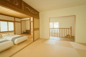 a bedroom with a bed and a balcony at The Lobs 4, 6BR 4BATH 8 mins to Rusutsu Brand new 2025 in Kimobetsu