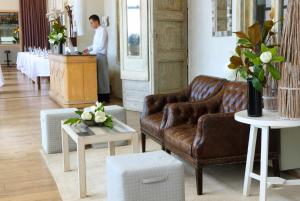 a man standing at a counter in a living room at Hostal Spa Empúries in L'Escala
