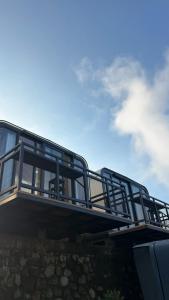 a balcony with a blue sky in the background at The Lakebox Menjer by Travelink in Garung