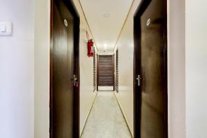 a hallway with two sets of doors and a long corridor at Hotel O MA Chidambaram Stadium Formerly Sarvanas Park in Chennai