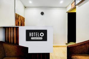 a room with a hotel sign on the wall at Hotel O MA Chidambaram Stadium Formerly Sarvanas Park in Chennai