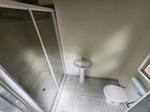 a bathroom with a shower and a toilet and a sink at Mkumbi Nyala Campsite in Neemane +6 photos