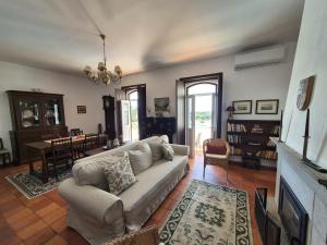 a living room with a couch and a table at Herdade do Vidigal in Montemor-o-Novo