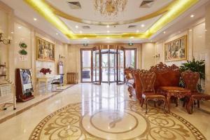 a living room with chairs and a table and a piano at Vienna Shanghai Chongming Changxing Island in Dongxing