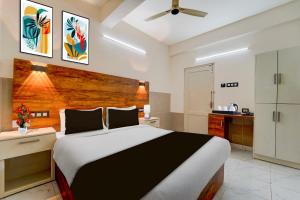 Ένα ή περισσότερα κρεβάτια σε δωμάτιο στο Super Townhouse Green Field Stadium Karyavattom