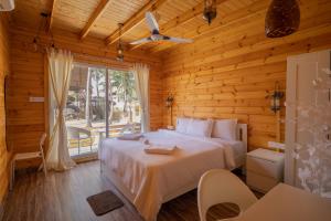 a bedroom with a bed and a large window at Ourem Palace in Palolem