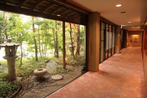 a hallway of a building with a view of a forest at Hotel New Kotobuki in Matsumoto
