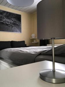 a bedroom with a bed and a table with a lamp at Ferienhaus Am Weiher in Waltershausen