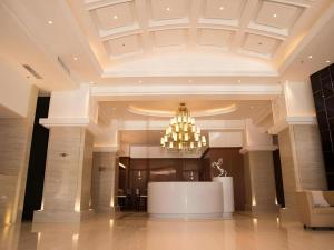 a large lobby with a chandelier in a building at Jinjiang Inn Select Hohhot Chengjisihan Square Metro Station in Hohhot