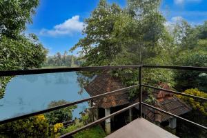 a view from the balcony of a villa with a pool at Super Collection O Chalakkudy River Annamanada Formerly Svasthya Retreat in Māla