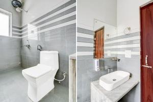 a bathroom with a white toilet and a sink at Super Hotel O Mehta College And Institute Of Technology Formerly Lara Heritage in Jaipur