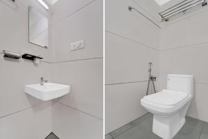 a white bathroom with a toilet and a sink at Super Collection O Chalakkudy River Annamanada Formerly Svasthya Retreat in Māla