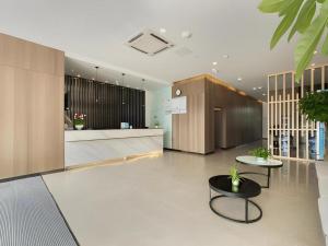 a lobby with two chairs and a table at Jinjiang Inn Select Xuzhou High-speed Railway Station Kunpeng Road in Xuzhou