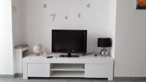 a white entertainment center with a television on it at Casa Meri in Montesilvano