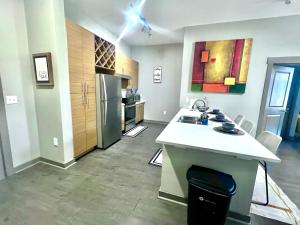 a kitchen with a counter and a refrigerator at Uptown Charlotte Modern Stay 2BR in Charlotte