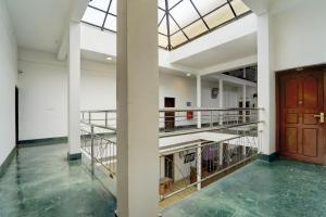 a large room with a staircase and a door at Super Collection O Kangarappady Formerly Cochin Residency in Kakkanad