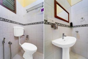a bathroom with a toilet sink and a mirror at Super Collection O Kangarappady Formerly Cochin Residency in Kakkanad