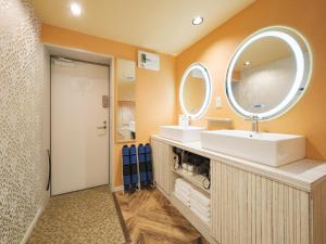 a bathroom with two sinks and a large mirror at Tomaru House J in Chiba