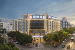 a large yellow building with writing on it in a city at Echarm Hotel Jianshui Gucheng in Jianshui