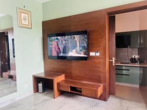 a living room with a television on a wall at Mastiff Citadel RC in Chūharpur