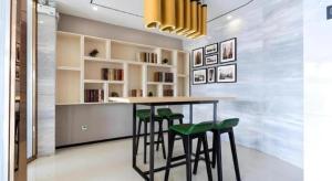 een keuken met een bar met groene krukken bij City Comfort Inn Jiangmen Enping Bus Terminal in Enping