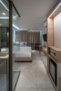 a living room with a bed and a couch and a table at Bluphere Residence by Prop Hopper in Na Jomtien