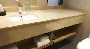 een badkamerbar met een wastafel en handdoeken bij City Comfort Inn Jiangxia Wuchang University of Technology in Wuhan +86 foto's