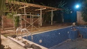 a house under construction with a swimming pool at night at Indunil Family Residence With Pool Hiriketiya in Dickwella